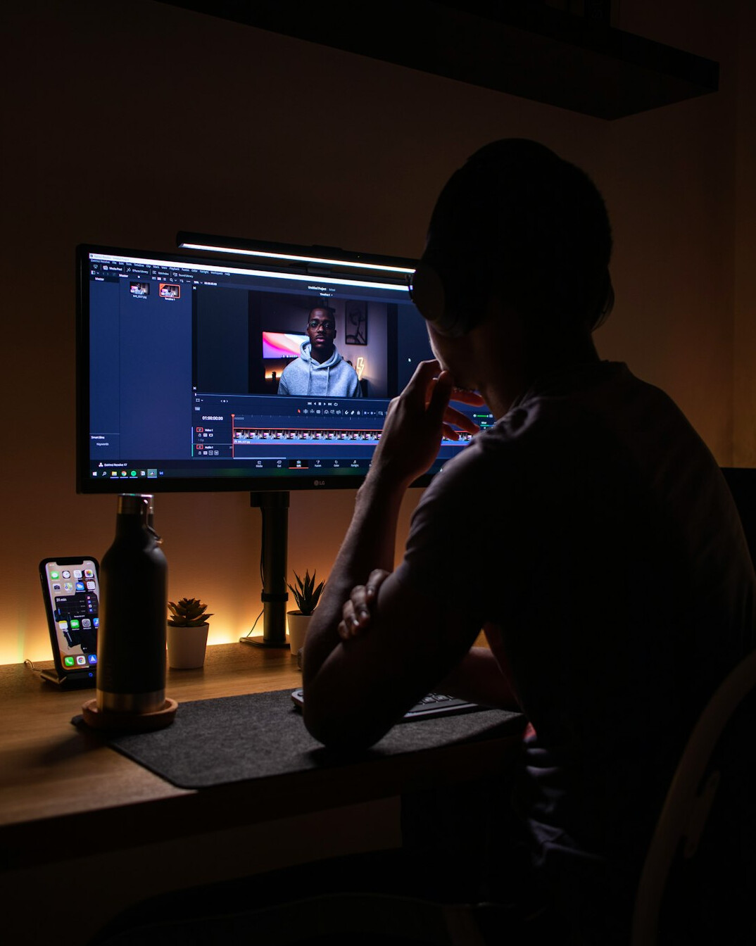 person editing video on computer